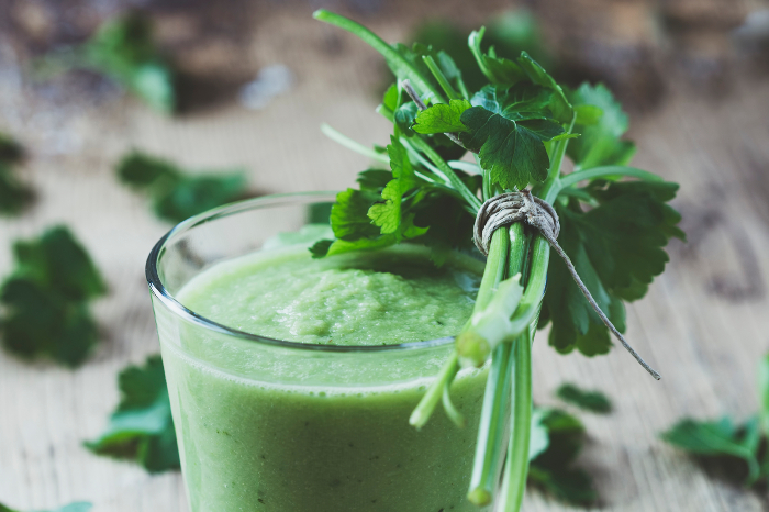 Green smoothie with parsley on wooden table. Rustic